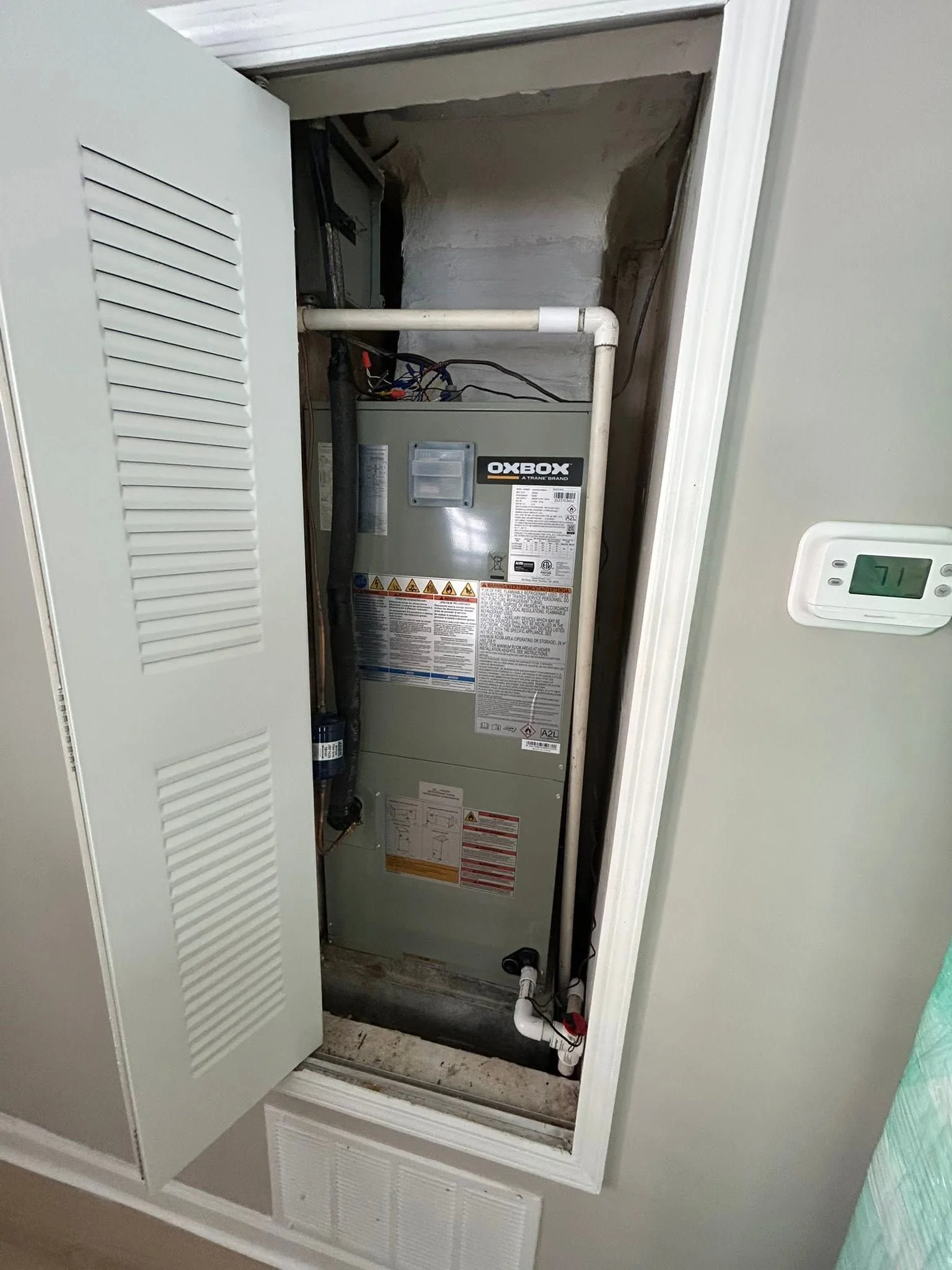 HVAC technician servicing an air conditioning unit