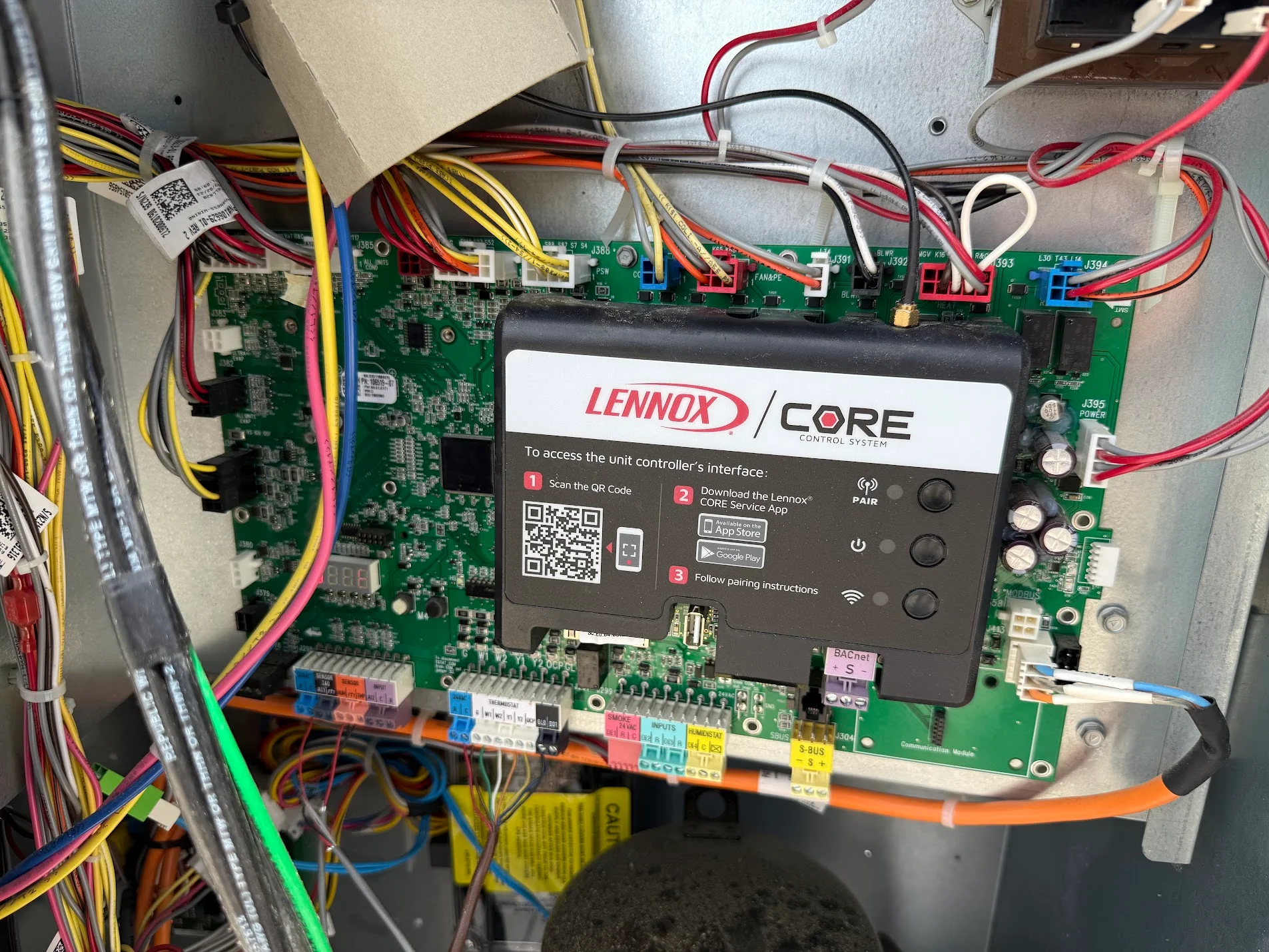 Lennox Core control system with green circuit boards, color-coded wiring, and smart interface display