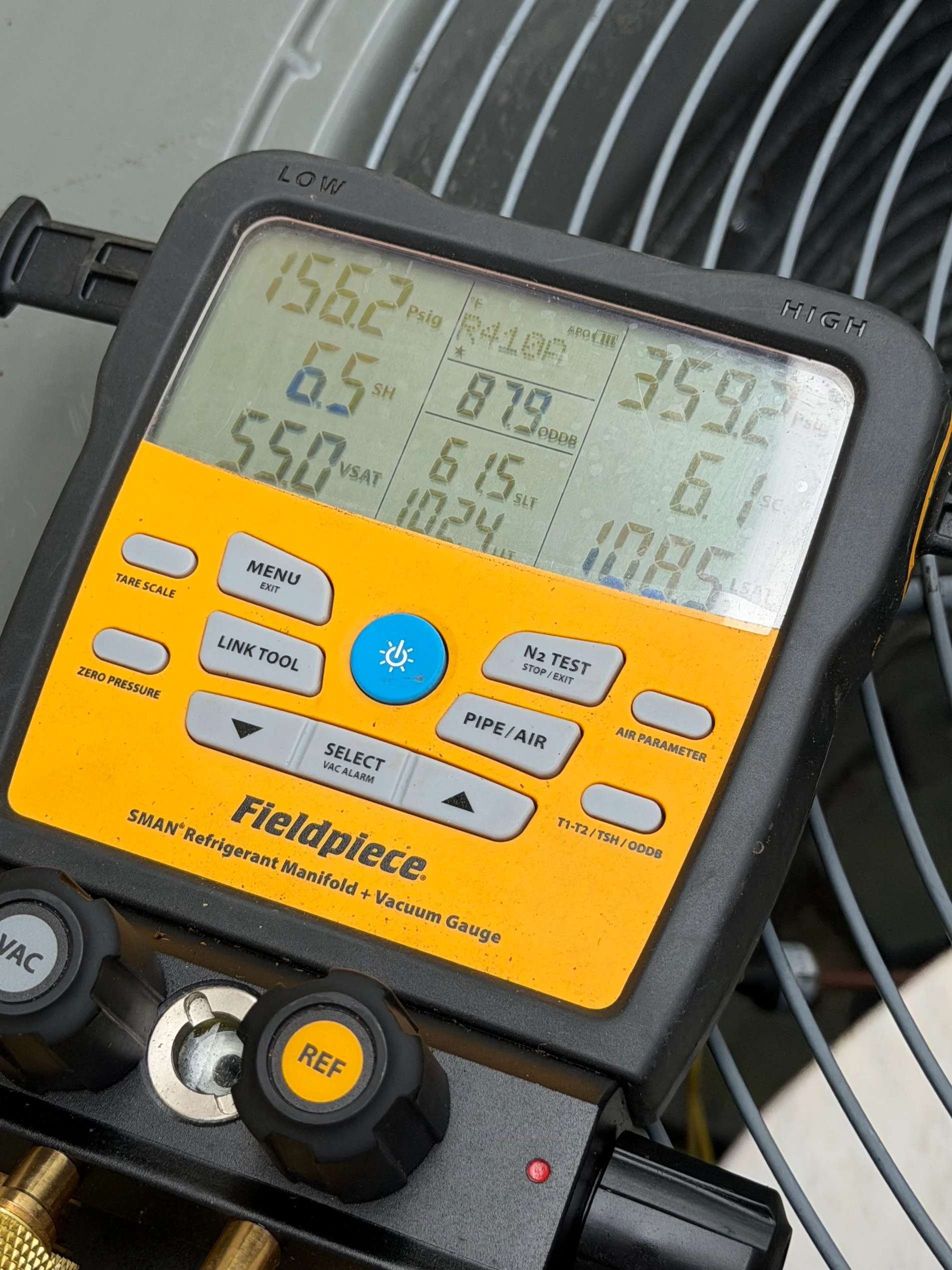 Fieldpiece digital manifold gauge displaying refrigerant pressure readings and HVAC system diagnostics